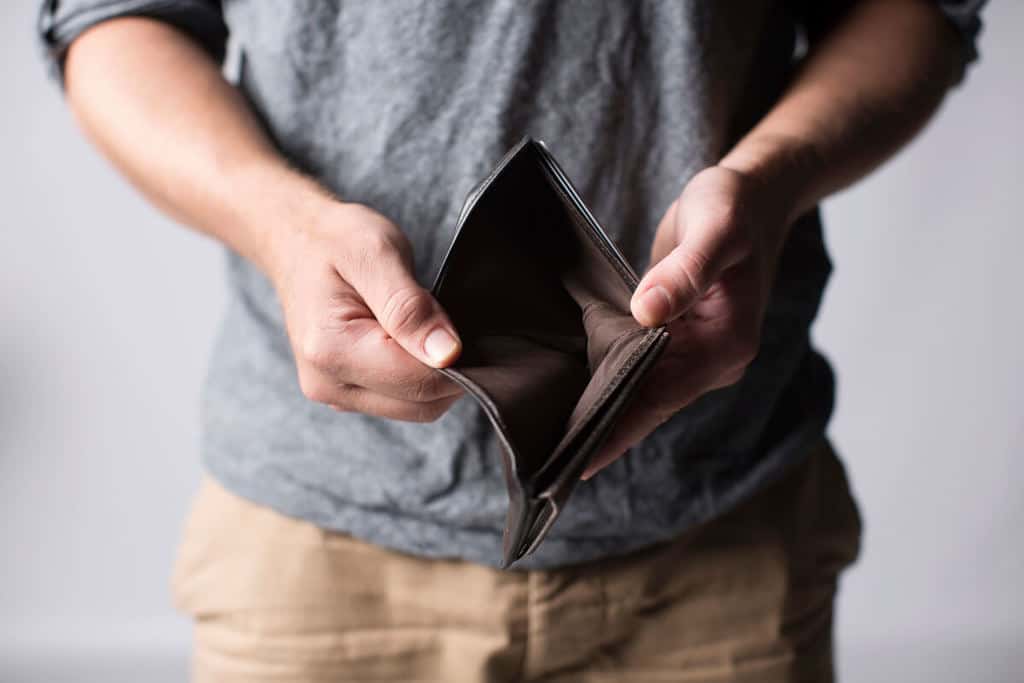 person holding empty wallet